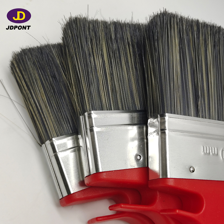 Paint brush with red plastic handle